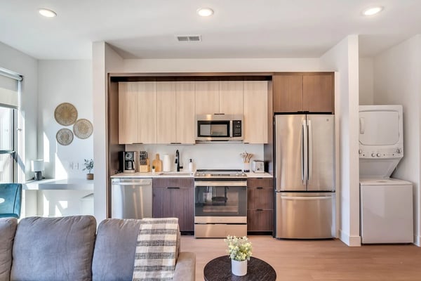 Modern luxury kitchen with striped wood ceiling, curved islands, geometric pendant lights, and floor-to-ceiling windows overlooking city skyline